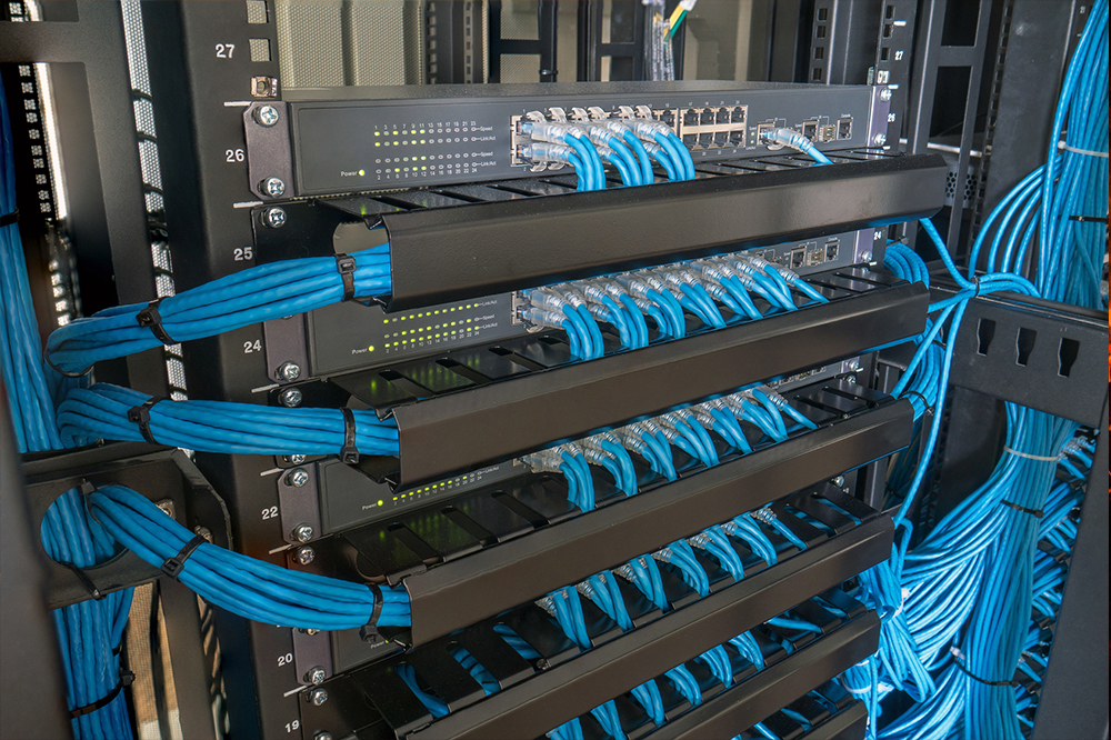 Image of Cat6 network cables plugged into multiple cisco routers